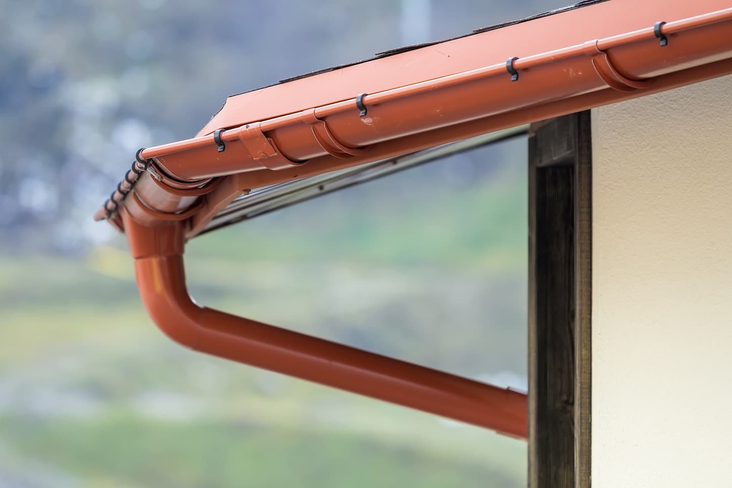 An image of a new roof with a gutter rain system in orange color.