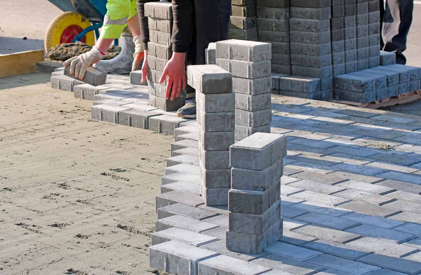 An image of garden brick pathway paving by professional paver workers.