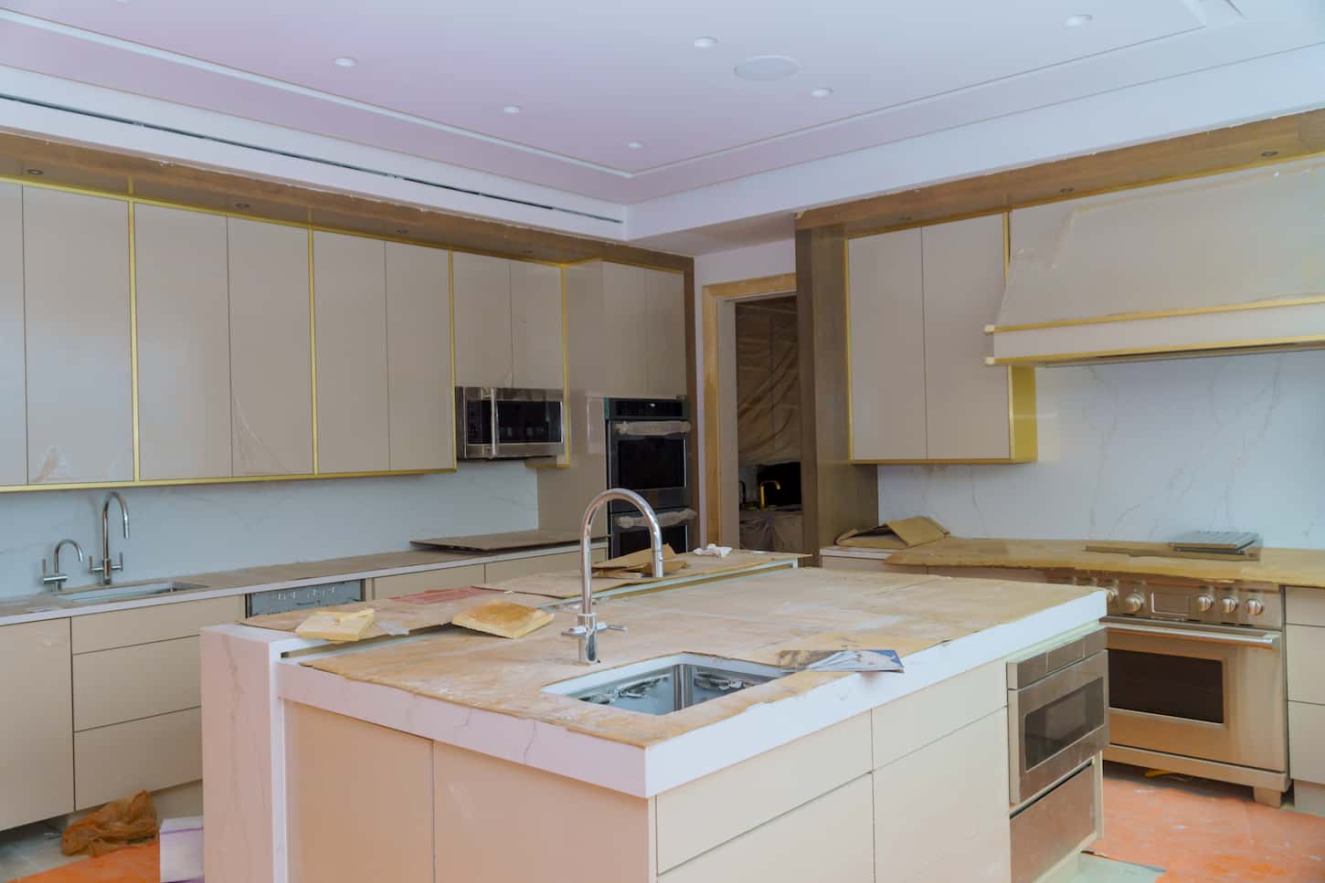 An image of Cabinet installation base for an island in center installation on kitchen countertops and sink.