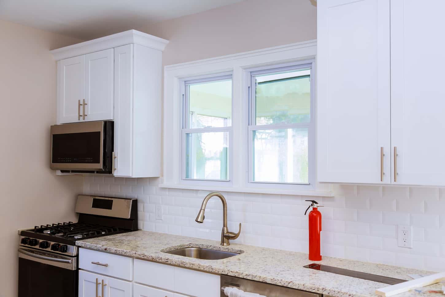 An image of Close up of a kitchen sink, worktop, and window in the kitchen, the square is the installation of the countertop.