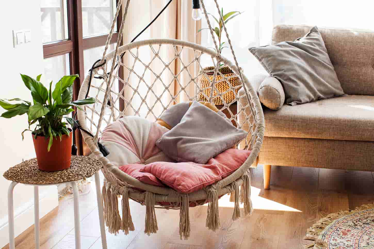 An image of a Hanging home rope swing in a Scandinavian interior. The concept of home life, hugge, home comfort.