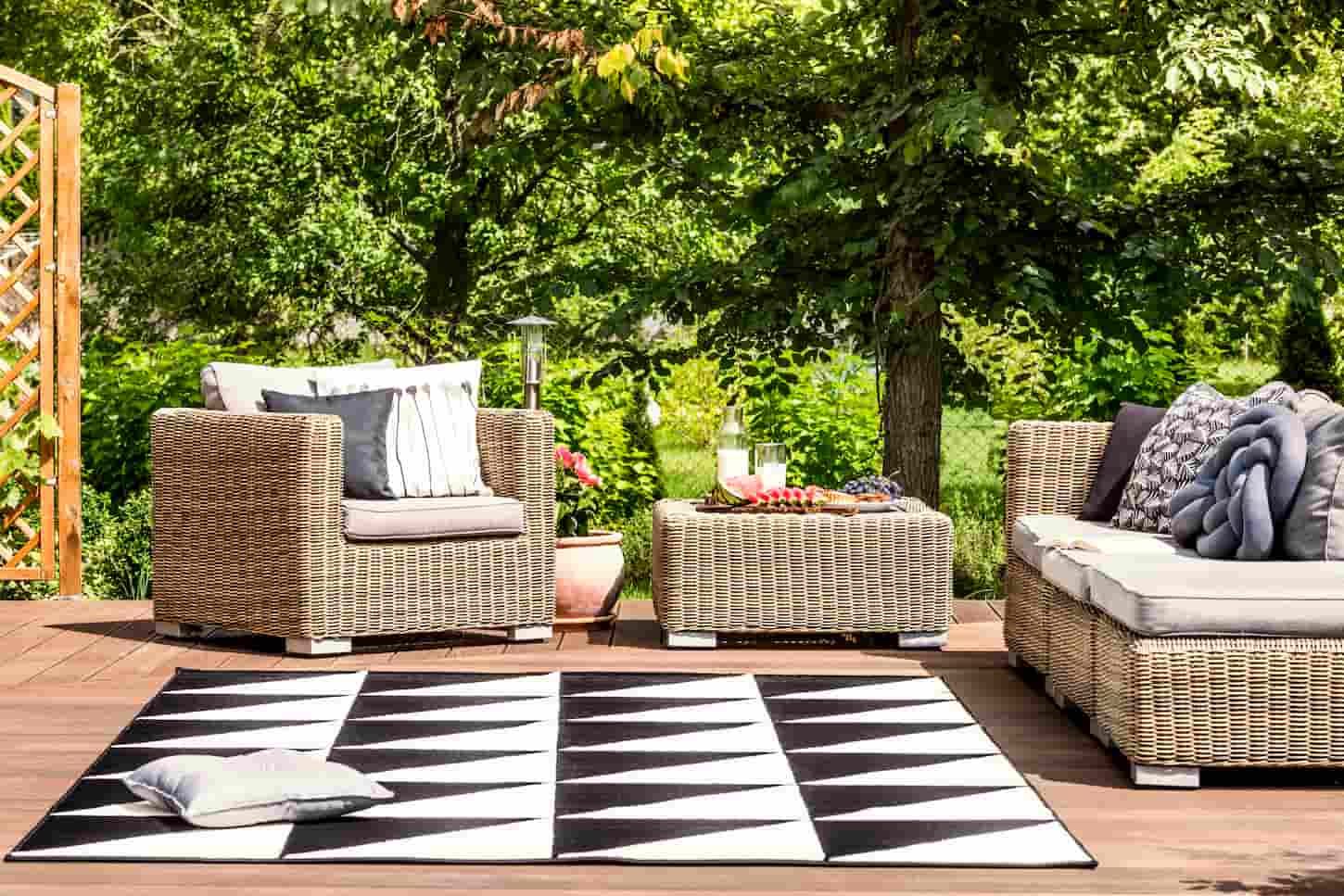 An image of Comfy garden furniture and a geometrical rug on a terrace in a spa resort.