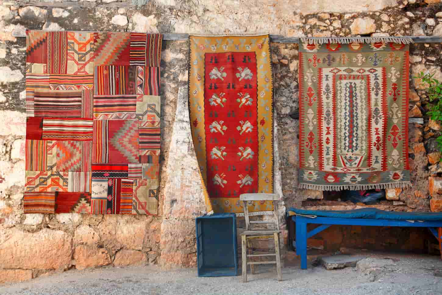An image of Turkish rugs on the wall in Simena.