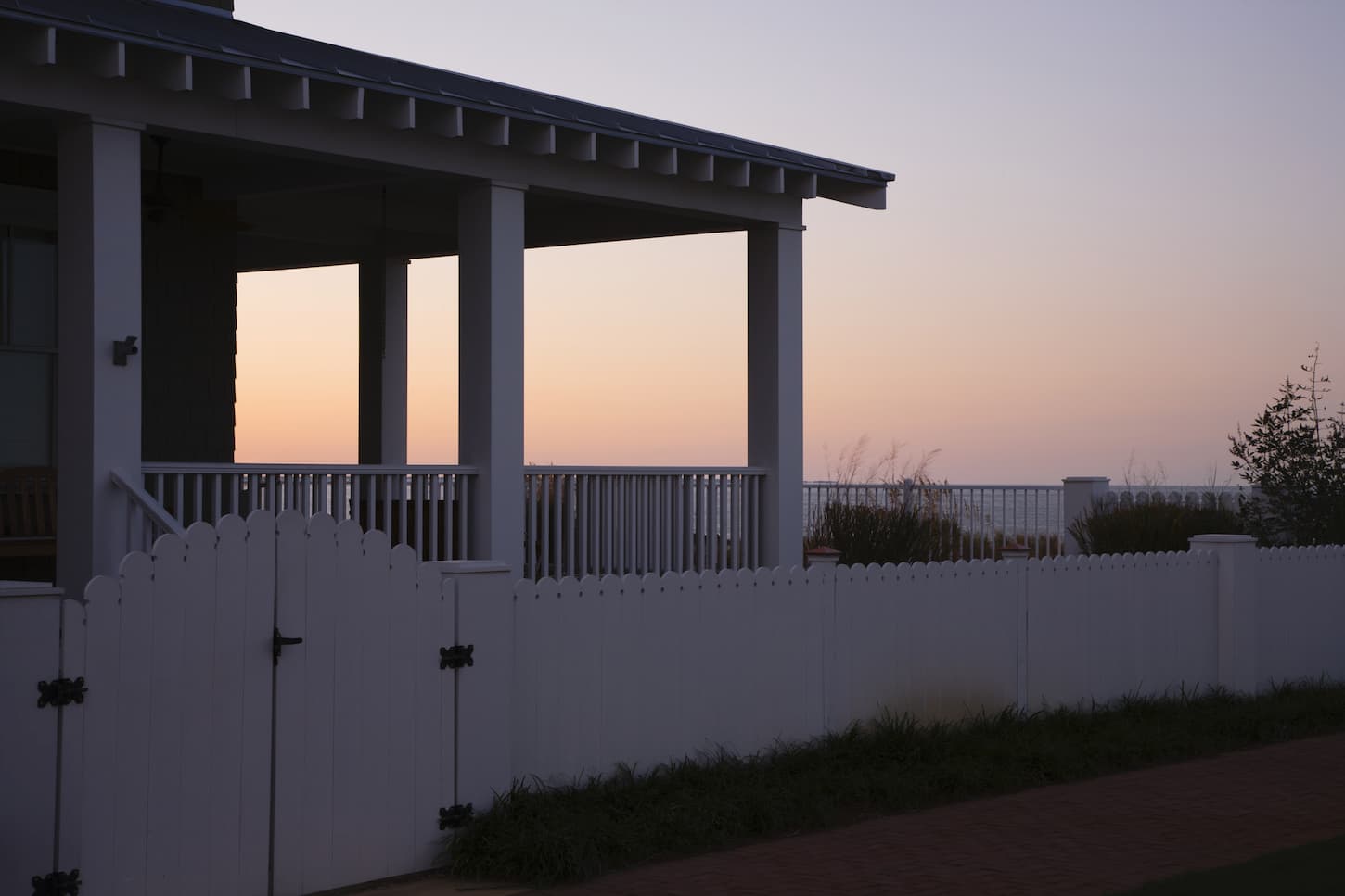 An image of a Covered Porch And Fence At Sunset.