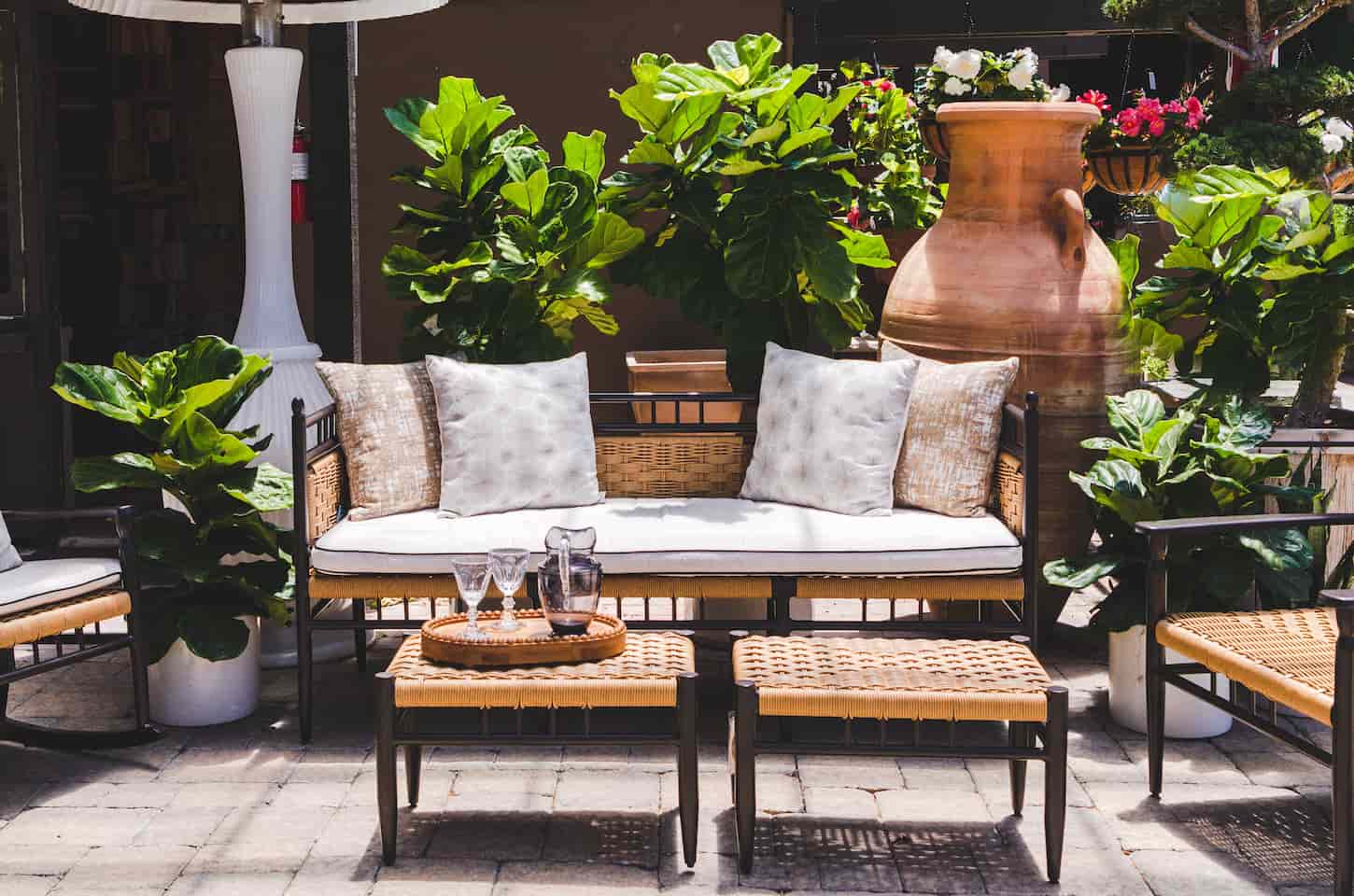 An image of an Outdoor living space - comfortable, inviting patio furniture with plants, ready for entertaining.