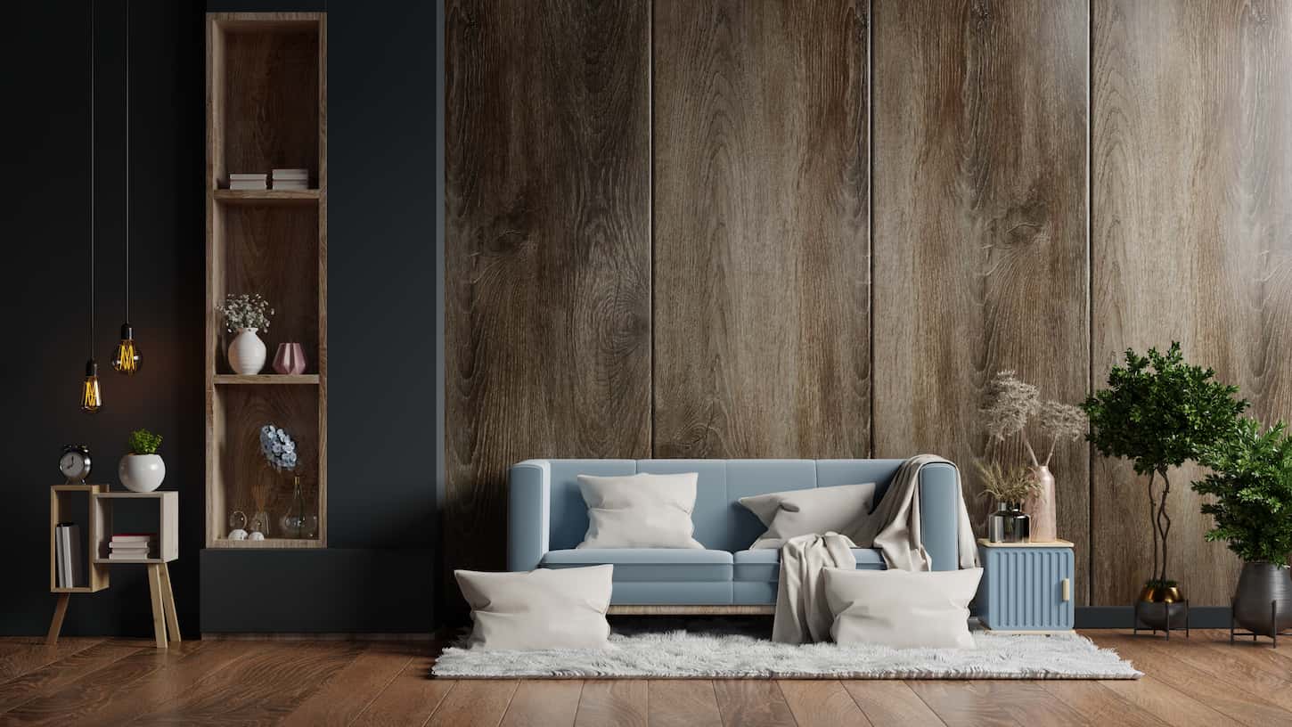 An image of a Living room interior that has a sofa on an empty dark wood wall.