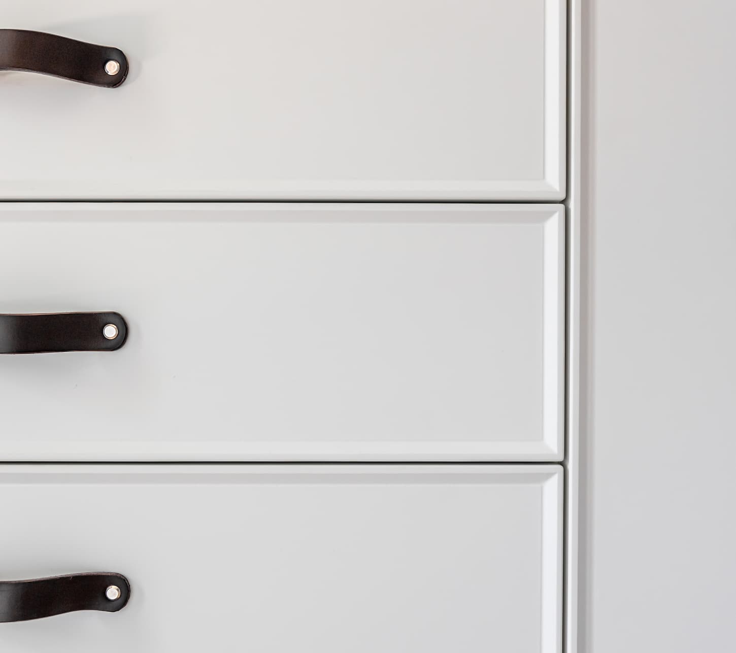 An image of Black handles of the kitchen drawer or cabinet.