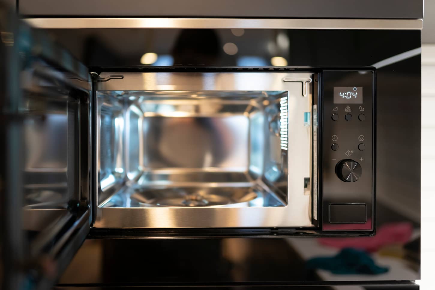 An image of a Modern built-in microwave oven with an open door.