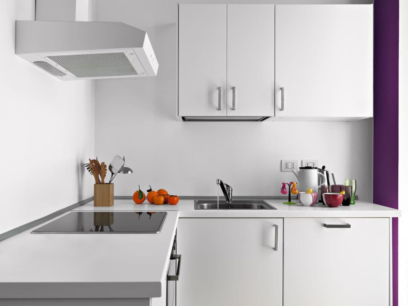An image of a modern kitchen interior with white furniture.